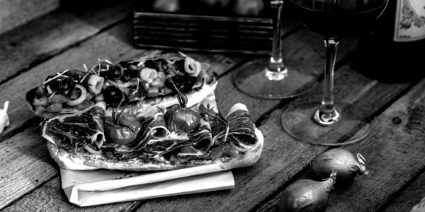 tapas-on-crusty-bread-with-red-wine-P2W8ASW-scaled-blackwhite